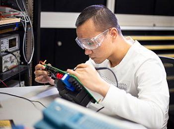 Student working on electronics